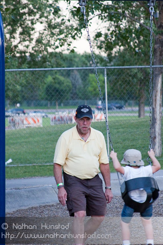 John Miller and Michael Weber playing on the swings at the Colorado Irish Festival